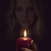 Red Candle Reflection Gallery Image | Meriem Chrrouhi Red candle in the foreground with a softly shadowed blonde woman behind it.