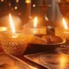 Lit candles in amber glass holders beside tarot cards on a warmly illuminated table.